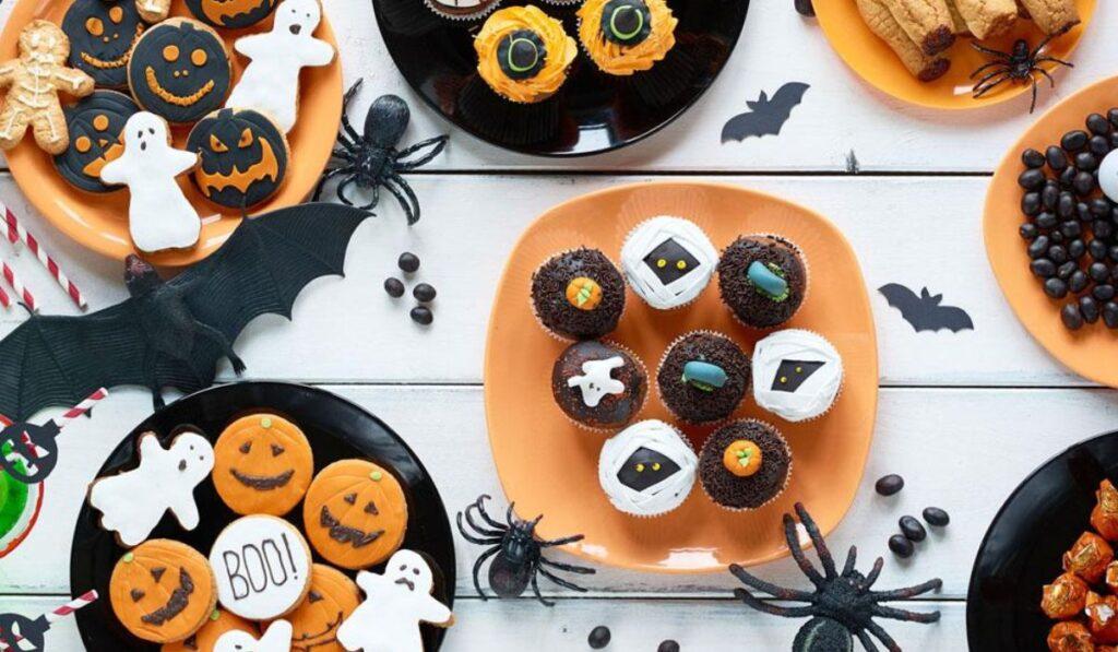 halloween snacks and cookies on plates
