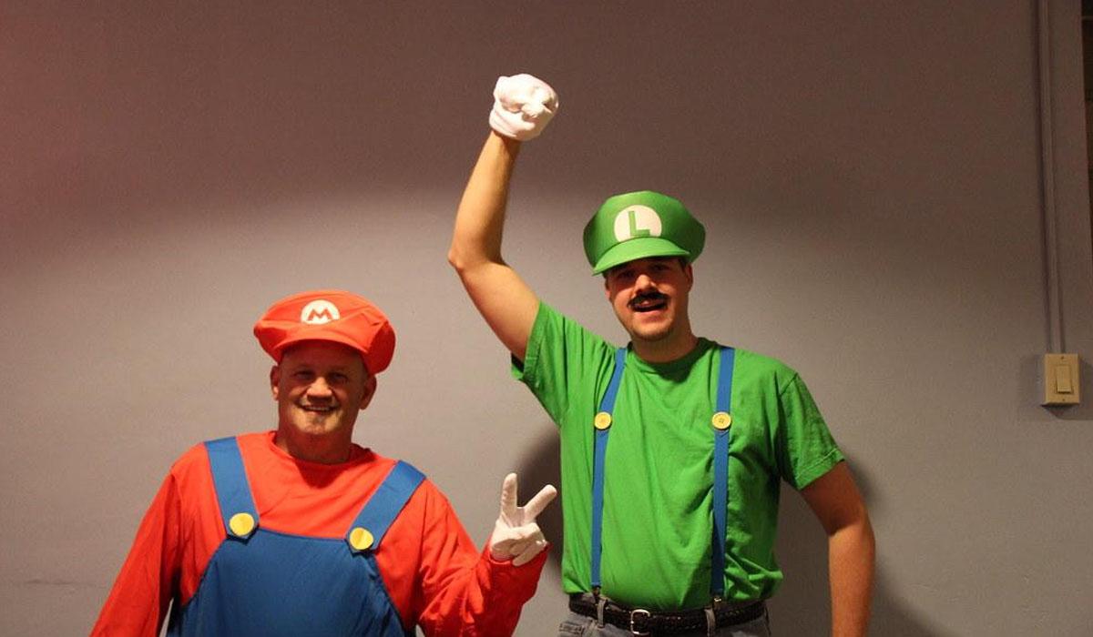two people dressed as mario and luigi for halloween