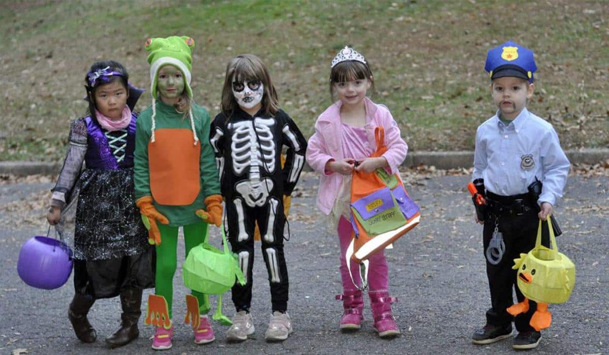 kids on the street wearing Halloween costumes