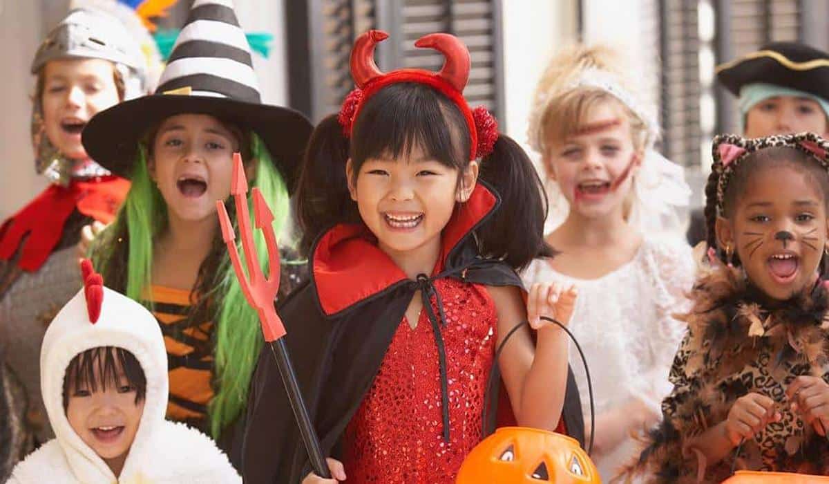 a group of kids Wearing Halloween Costumes