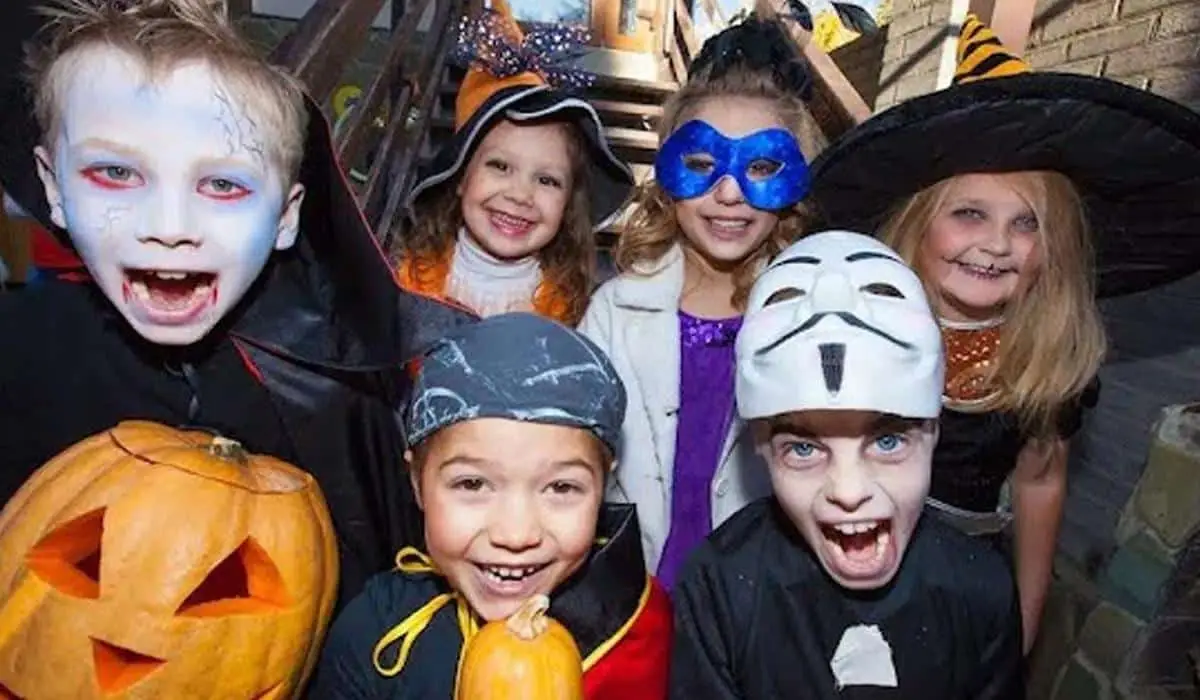 a group of children dressed in Halloween costumes