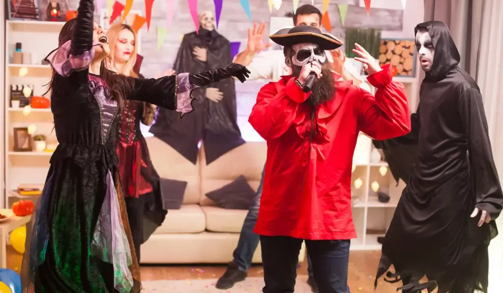 Costumed friends enjoying halloween party games with festive decorations and lively atmosphere for a spooky celebration.