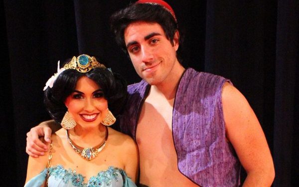 a man and woman wearing an Aladdin and Jasmine costume